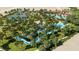 Aerial view of community pool with water features, tennis courts, and a lazy river at 5416 Solterra Cir, Davenport, FL 33837