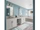 Modern bathroom with double vanities, a soaking tub, and neutral color scheme at 5416 Solterra Cir, Davenport, FL 33837