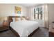 Bright bedroom featuring contemporary lamps, neutral tones and a decorative modern print at 5416 Solterra Cir, Davenport, FL 33837