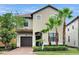 Charming two-story home featuring a tile roof, stucco exterior, and well-manicured landscaping at 5416 Solterra Cir, Davenport, FL 33837