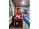 Amazing game room features space-themed murals, skee ball and basketball toss games at 5416 Solterra Cir, Davenport, FL 33837