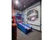 Amazing game room features space-themed murals, modern lighting, and blue skee ball machine at 5416 Solterra Cir, Davenport, FL 33837