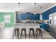 Modern kitchen with stylish blue cabinetry, granite countertops, and stainless steel appliances at 5416 Solterra Cir, Davenport, FL 33837