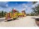Community playground with fun structures, climbing equipment, and sand area at 5416 Solterra Cir, Davenport, FL 33837