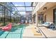 Resort-style screened-in pool with lounge chairs, spa, and outdoor seating perfect for relaxation at 5416 Solterra Cir, Davenport, FL 33837