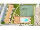 Overhead view shows the pool and tennis courts, surrounded by well-kept buildings and parking at 5763 Saint Christopher Dr # 55, Orlando, FL 32822