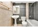 Beautifully tiled bathroom with pedestal sink, toilet and tiled shower-tub combination at 5763 Saint Christopher Dr # 55, Orlando, FL 32822