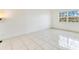 An airy bedroom with large window and tile floors at 5763 Saint Christopher Dr # 55, Orlando, FL 32822