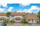 Inviting townhouse with a well-manicured lawn, covered entrances, and a classic architectural design at 5763 Saint Christopher Dr # 55, Orlando, FL 32822