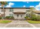 Inviting condo exterior featuring well-maintained landscaping and a shared entrance at 5763 Saint Christopher Dr # 55, Orlando, FL 32822
