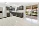 A well-lit kitchen with stainless steel appliances and dark cabinets, adjacent to a patio at 5763 Saint Christopher Dr # 55, Orlando, FL 32822