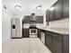 A kitchen with stainless steel appliances and dark gray cabinetry, featuring tile flooring at 5763 Saint Christopher Dr # 55, Orlando, FL 32822