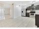 Bright kitchen with tile floors, stainless steel appliances, and grey cabinets at 5763 Saint Christopher Dr # 55, Orlando, FL 32822