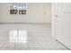 Bright and spacious living room with neutral tile floors and large window at 5763 Saint Christopher Dr # 55, Orlando, FL 32822