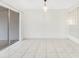 Empty living room space with tile flooring and sliding glass door to the patio at 5763 Saint Christopher Dr # 55, Orlando, FL 32822