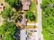 Aerial view of a single-story home with a long driveway surrounded by lush trees at 5831 Nw 58Th Ter, Ocala, FL 34482