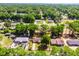 An aerial view showing the home on a tree covered lot with adjacent homes and street at 5831 Nw 58Th Ter, Ocala, FL 34482