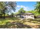 A well maintained backyard with beautiful shady tree and a patio with seating for two at 5831 Nw 58Th Ter, Ocala, FL 34482