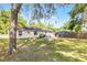 A home featuring a well maintained backyard, a shady tree, and seating for two at 5831 Nw 58Th Ter, Ocala, FL 34482
