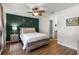 Cozy bedroom with a rustic wooden bed frame, accent wall, and decorative touches at 5831 Nw 58Th Ter, Ocala, FL 34482