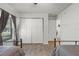 Light-filled bedroom offering a view of closet doors and a neutral rug at 5831 Nw 58Th Ter, Ocala, FL 34482