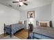 Cozy bedroom with two beds, stylish wall art, and hardwood floors at 5831 Nw 58Th Ter, Ocala, FL 34482