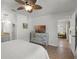 Bedroom features ceiling fan, dresser with TV, and ensuite bathroom at 5831 Nw 58Th Ter, Ocala, FL 34482