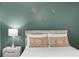 Bedroom with decorative wall hangings, plush pillows, and a nightstand at 5831 Nw 58Th Ter, Ocala, FL 34482