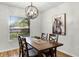 Bright dining room with a dark wood table, four chairs, and modern light fixture at 5831 Nw 58Th Ter, Ocala, FL 34482