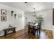 Bright dining room features hardwood floors, dining table, and modern light fixture at 5831 Nw 58Th Ter, Ocala, FL 34482