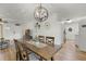 Dining room with hardwood floors, dining table, and modern light fixture at 5831 Nw 58Th Ter, Ocala, FL 34482