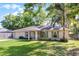 Well-maintained home with a manicured lawn, mature trees, and a concrete driveway at 5831 Nw 58Th Ter, Ocala, FL 34482