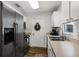 Features modern stainless-steel appliances, white cabinets, and wood-look floors at 5831 Nw 58Th Ter, Ocala, FL 34482