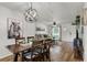 Open-concept living room and dining area with modern furnishings and wood laminate flooring at 5831 Nw 58Th Ter, Ocala, FL 34482