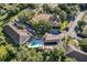 Aerial view of community buildings, pool, parking areas, and surrounding green spaces at 610 Cranes Way # 207, Altamonte Springs, FL 32701