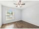 Cozy bedroom with updated flooring, a ceiling fan, and large window at 610 Cranes Way # 207, Altamonte Springs, FL 32701