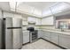 Kitchen features stainless appliances, light countertops, and tile floors at 610 Cranes Way # 207, Altamonte Springs, FL 32701