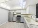 Kitchen features stainless appliances, light countertops, tile floors, and a double oven at 610 Cranes Way # 207, Altamonte Springs, FL 32701