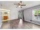Open living room with wood-look flooring flowing to the bathroom and outside at 610 Cranes Way # 207, Altamonte Springs, FL 32701