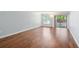Bright living room with wood floors and a sliding glass door allowing access to the porch at 610 Cranes Way # 207, Altamonte Springs, FL 32701