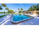 Community swimming pool with clear blue water and surrounding lounge area with palm trees at 610 Cranes Way # 207, Altamonte Springs, FL 32701