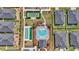 An aerial view shows community pool, tennis and shuffleboard courts with landscaped grounds and community homes at 7563 Sw 78Th Ter, Ocala, FL 34481