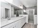 Bathroom features double sink vanity with quartz countertop and a glass-enclosed shower at 7563 Sw 78Th Ter, Ocala, FL 34481