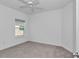 Bedroom with carpet, fan, and window providing natural light and view at 7563 Sw 78Th Ter, Ocala, FL 34481