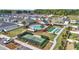 Community amenities view including a pool, shuffleboard, and tennis courts surrounded by landscaped grounds at 7563 Sw 78Th Ter, Ocala, FL 34481