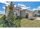 Charming home featuring stone accents, a well-manicured lawn, and lush landscaping at 7563 Sw 78Th Ter, Ocala, FL 34481