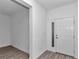 Bright foyer features neutral color palette, wood-look tile flooring, and entry door with sidelight at 7563 Sw 78Th Ter, Ocala, FL 34481