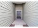Close-up of the front entrance featuring a modern, dark-colored door and contemporary siding at 7563 Sw 78Th Ter, Ocala, FL 34481