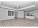 Open living space with wood-look floors, natural light, and seamless flow to the kitchen at 7563 Sw 78Th Ter, Ocala, FL 34481