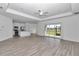 Open concept living space with wood-look floors, modern lighting, and a seamless flow to the kitchen at 7563 Sw 78Th Ter, Ocala, FL 34481